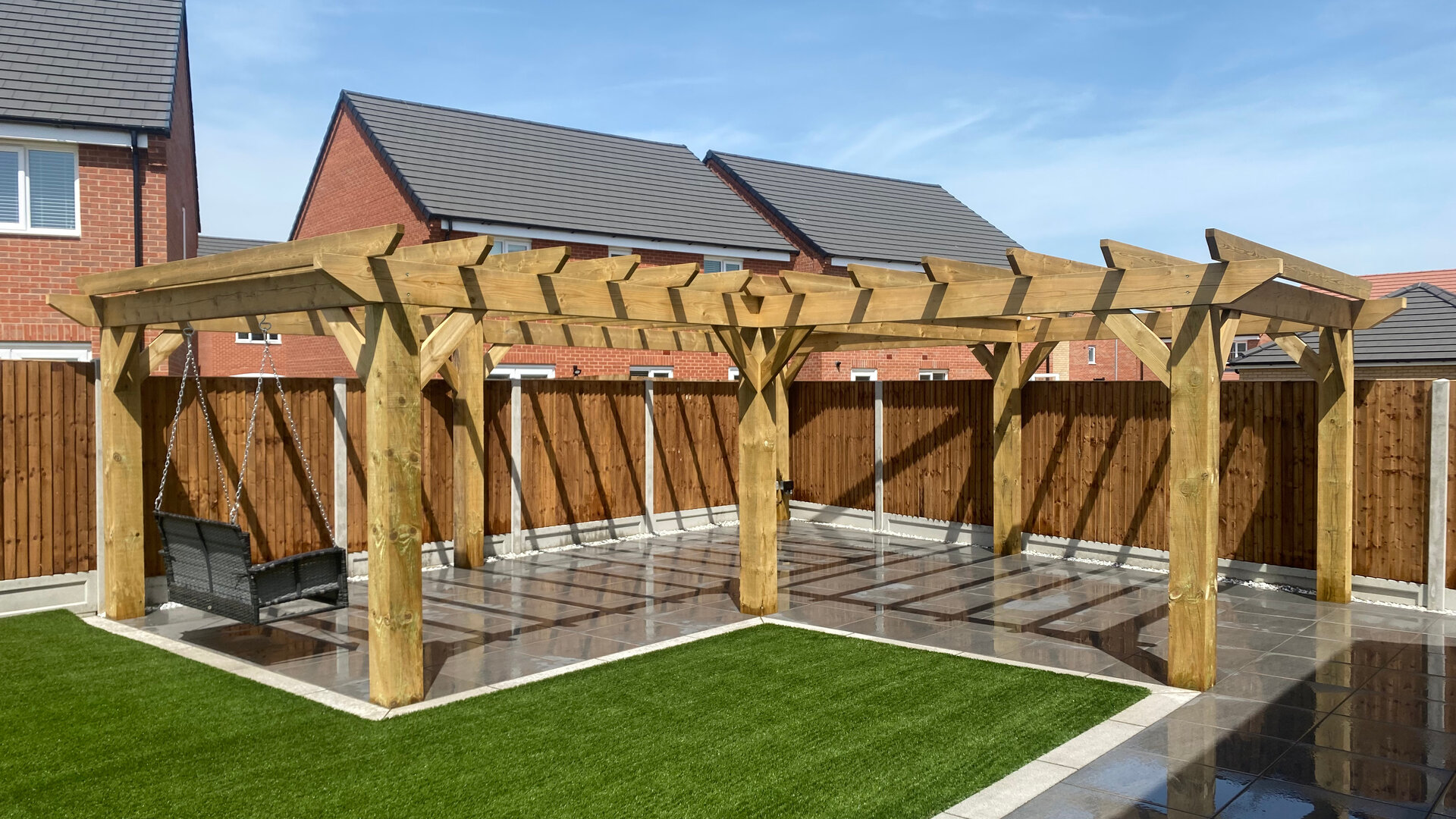 Beautiful garden with artificial grass and porcelain paving